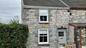 A stone building with a wooden gate, a window, and a door. - Penderyn Cottage, Waterfall Country, Brecon Beacons (Aberdare)