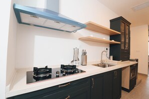 Enjoy cooking in this well-equipped kitchen with a gas stove, oven, and stainless steel sink.