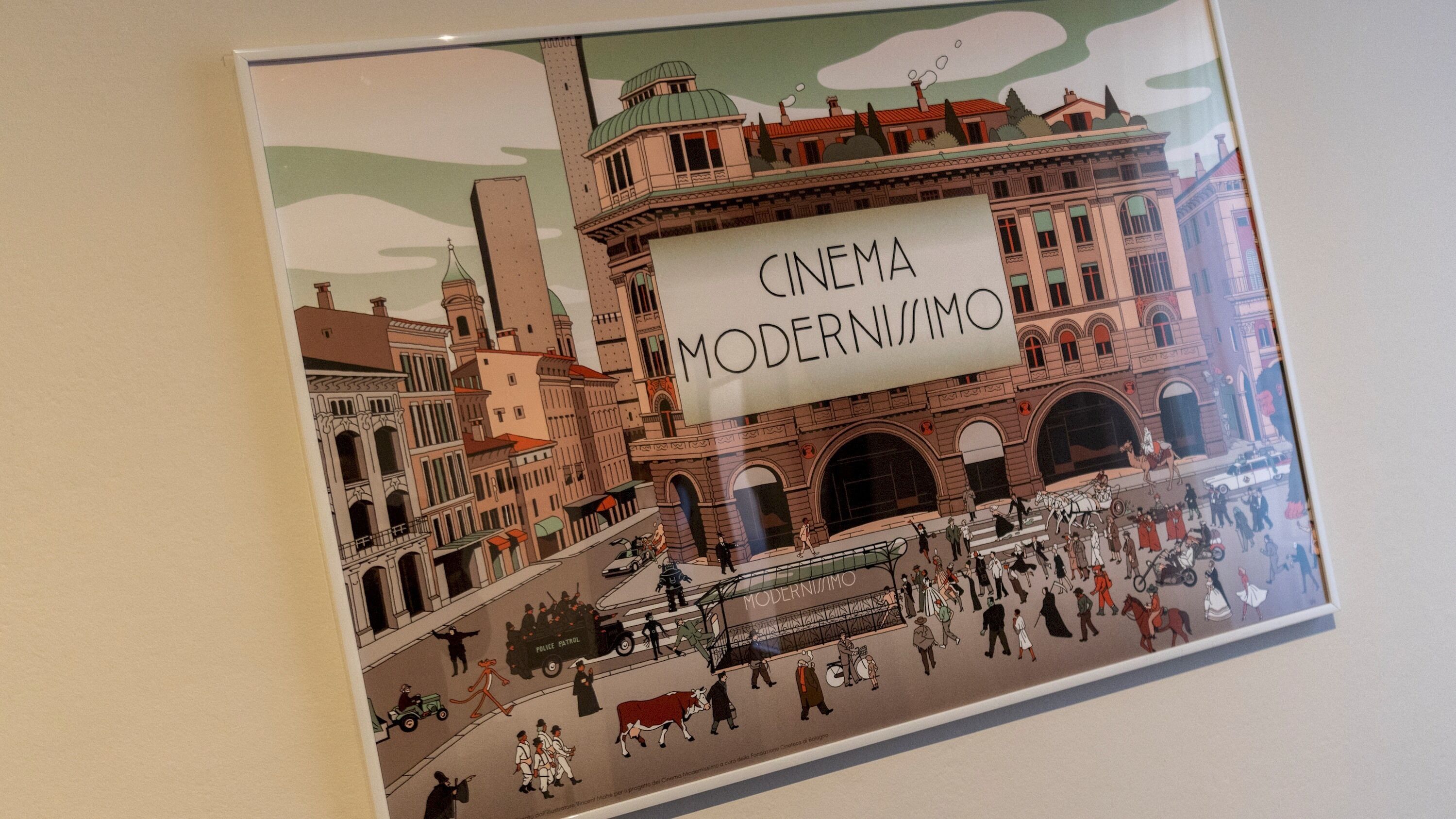 A poster with the text "CINEMA MODERNISMO" and a depiction of a cityscape with buildings and people.