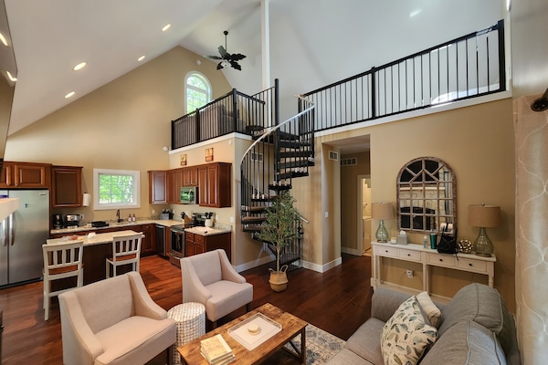 Vaulted ceilings, open floorplan, and loft with additional queen bed.