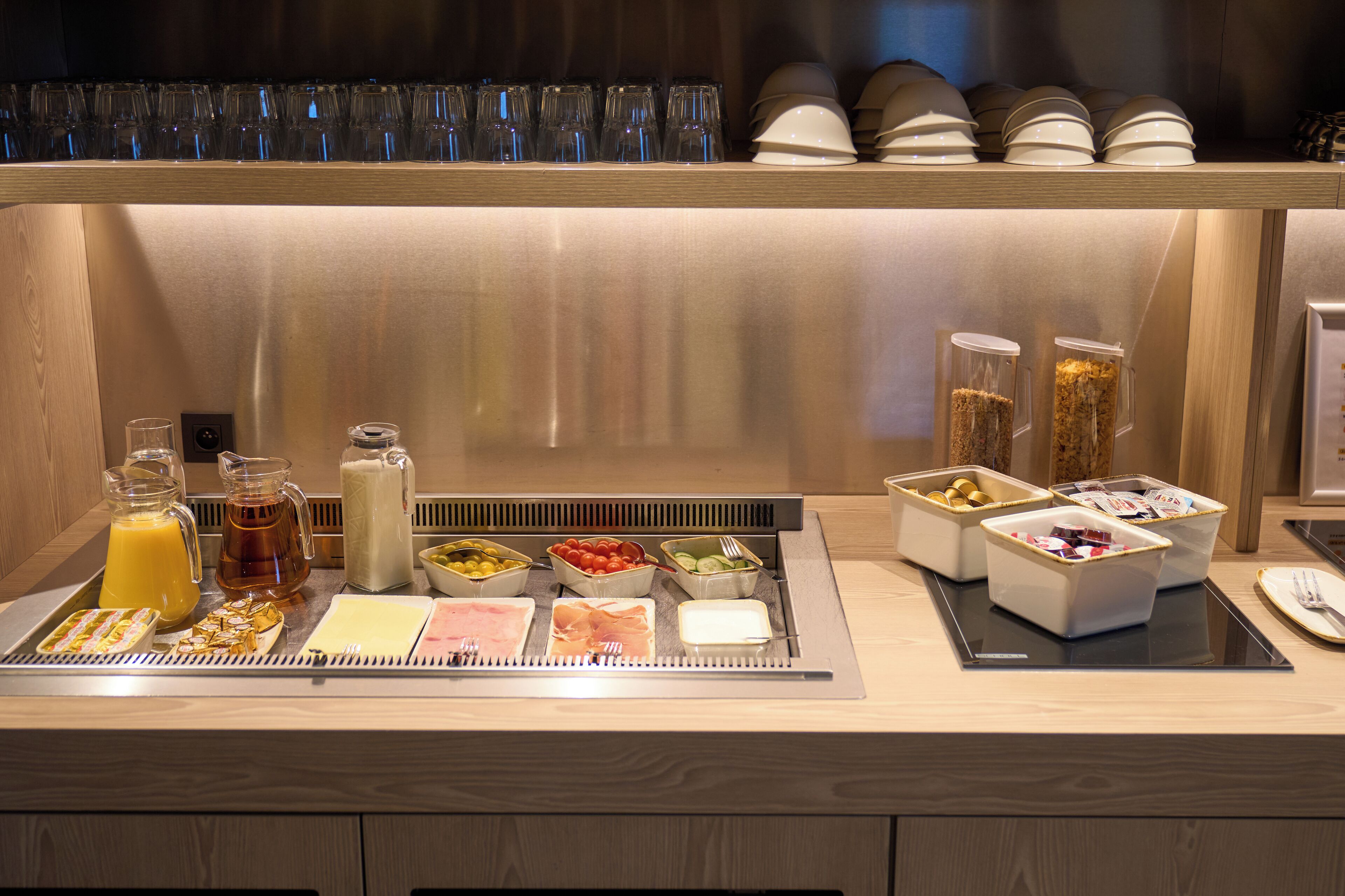 A breakfast buffet with various food items and beverages.