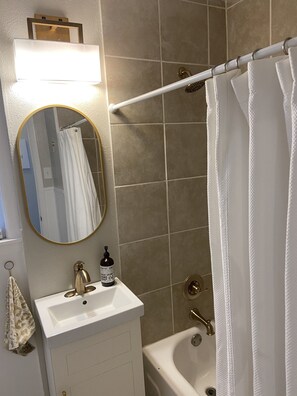 Combined shower/bathtub, hair dryer, towels, toilet paper