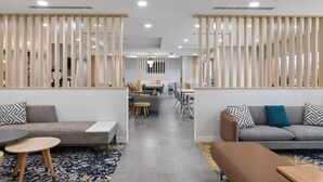 A modern interior with a sofa, coffee table, and dining area.