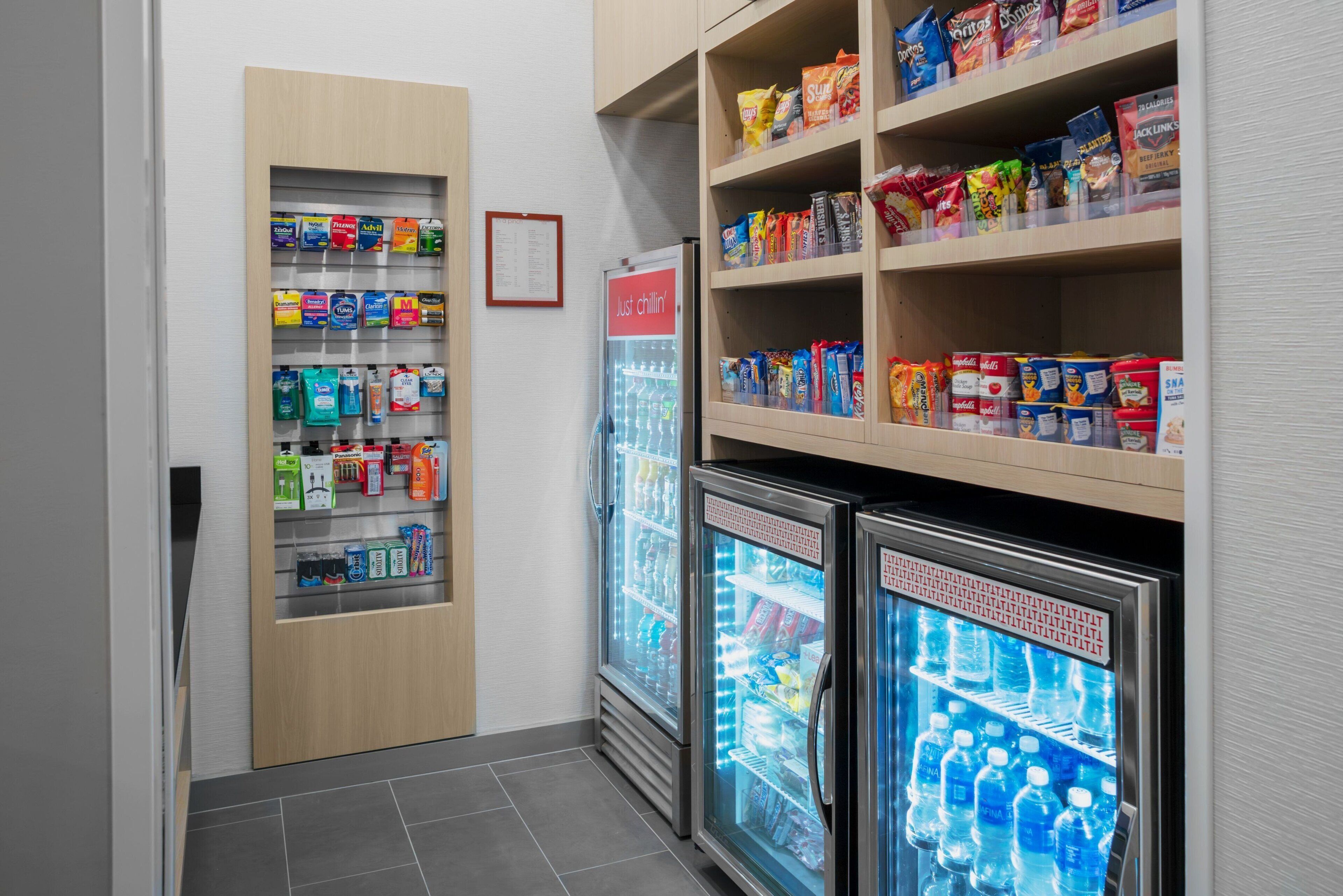 A refrigerated snack display with various packaged foods and beverages.