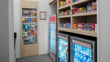 A refrigerated snack display with various packaged foods and beverages.