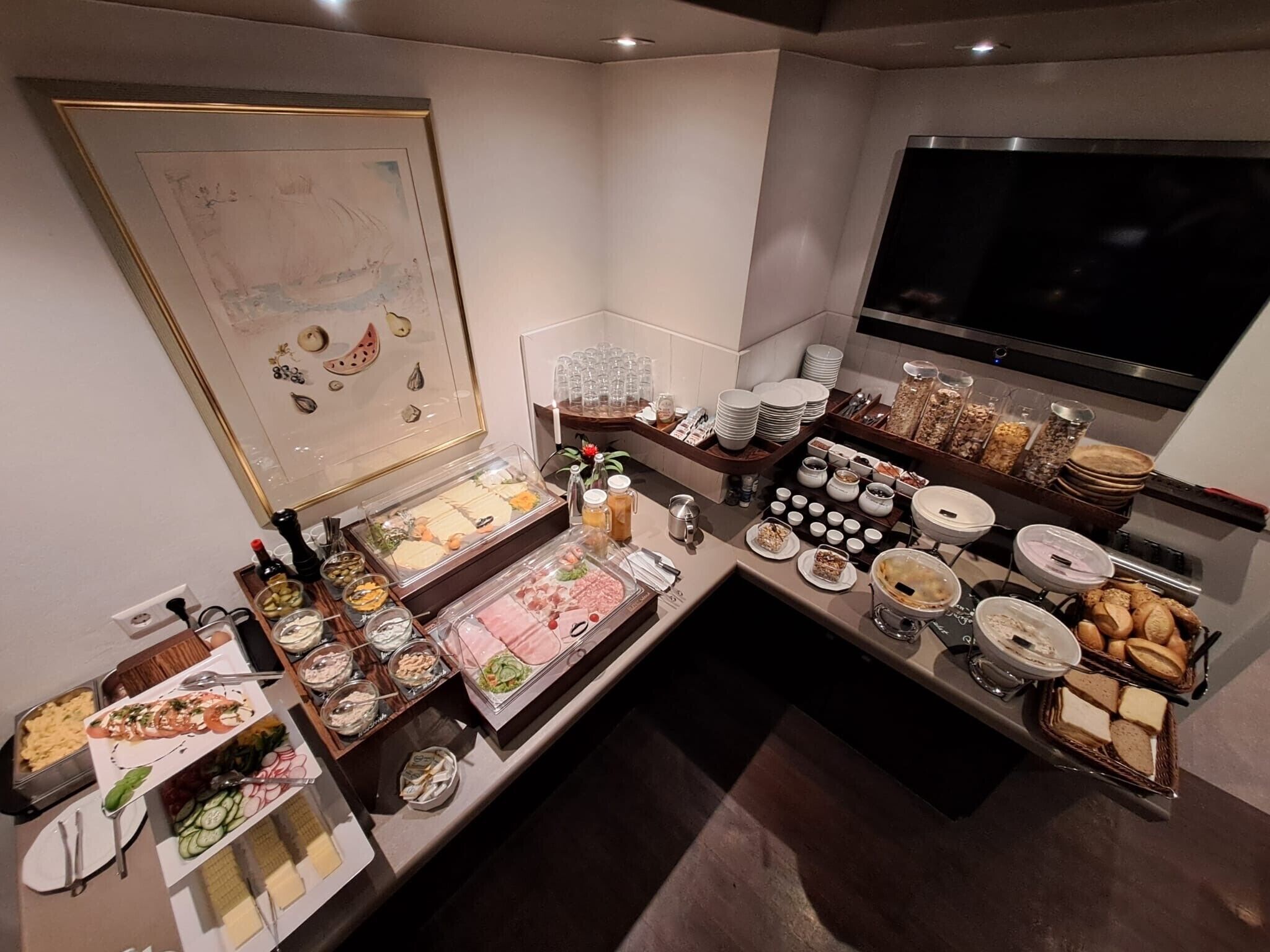 A buffet setup with various food items and condiments.