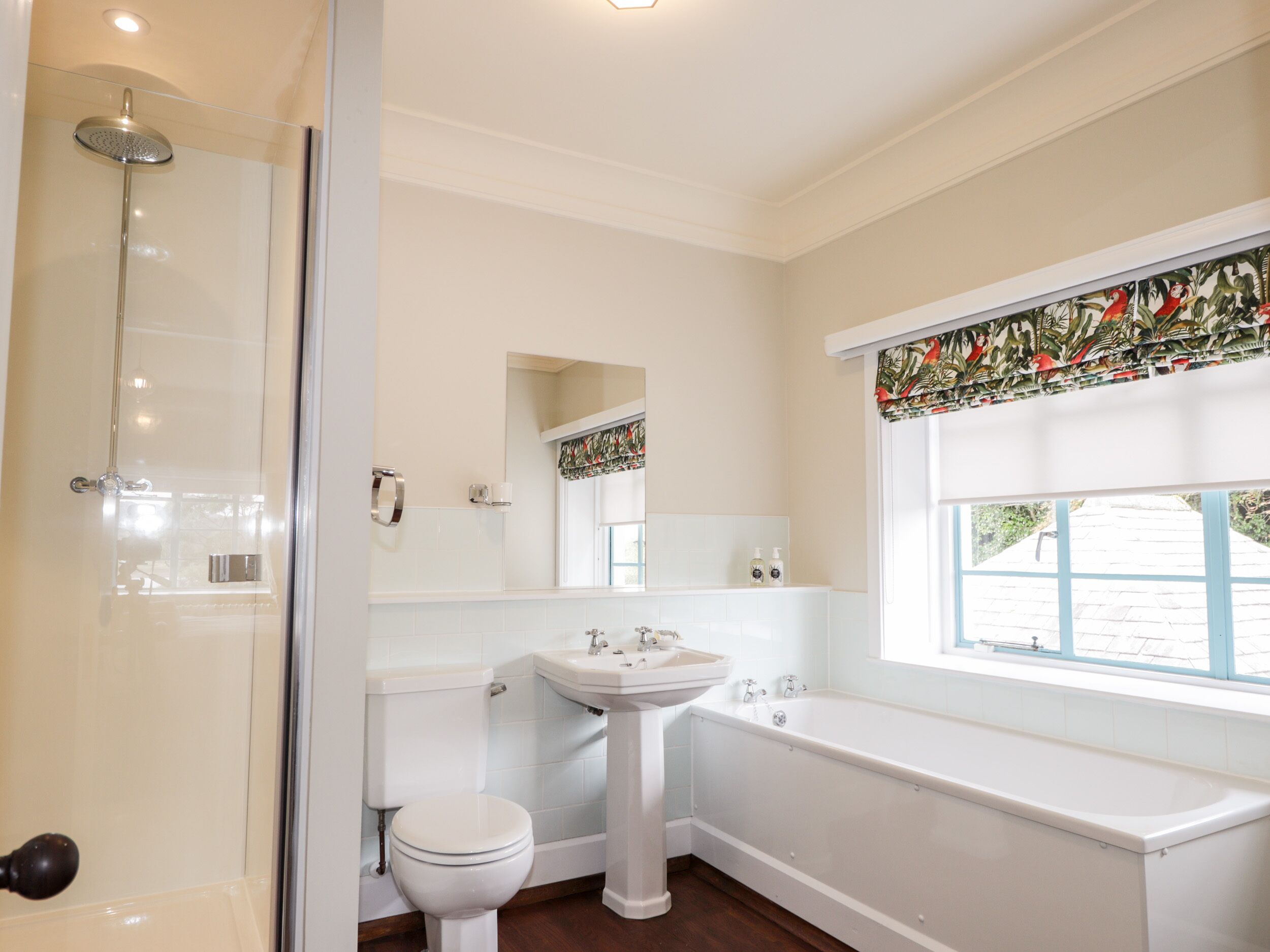 A bathroom with a shower, toilet, sink, and bathtub.