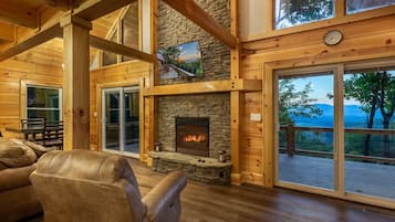 Comfort Cabin, 2 Bedrooms, Patio, Mountain View | Living room | 65-inch Smart TV with cable channels, TV, fireplace