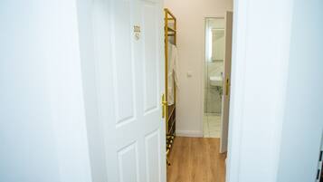 A hallway with a white door marked '101' and a white towel hanging on a rack.