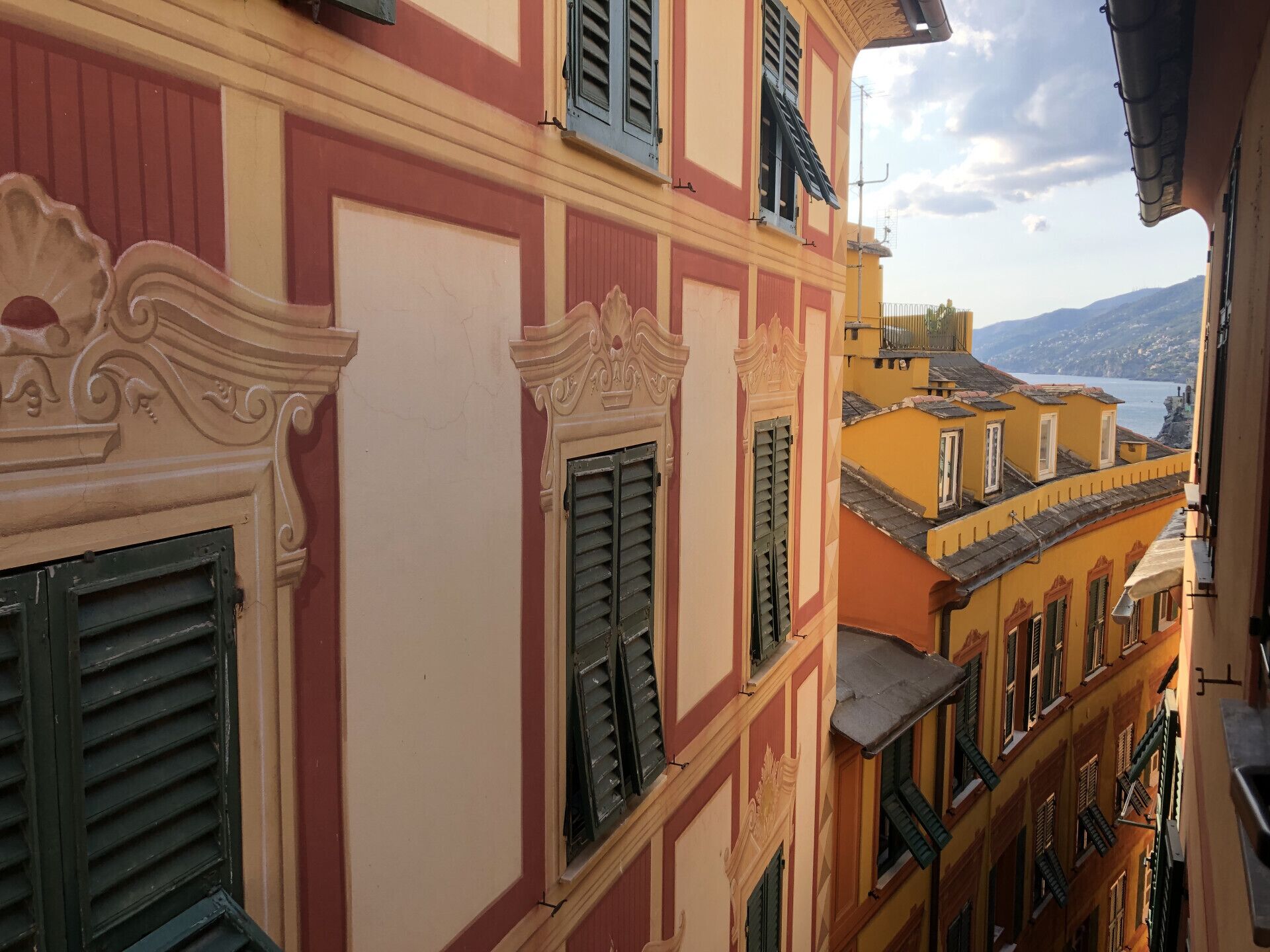 A multi-story building with ornate architectural details, including decorative moldings and shutters.