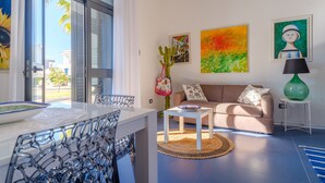 Una sala moderna con un sofá, una mesa de centro y obras de arte en las paredes.