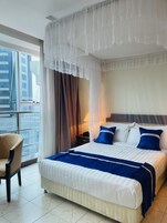 Premium bedding, desk, laptop workspace, soundproofing