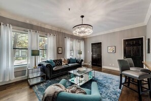 Smart TV - Bright 1-bedroom condo combining historic charm with modern comfort. Features a spacious living area with elegant furnishings, crystal lighting, and abundant natural light for a refined Dallas stay. (Dallas)