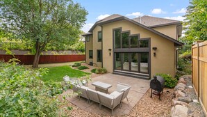 A modern house with a patio, outdoor furniture, and a barbecue grill. - MINNeSTAY* Dean Parkway Estate Luxury | Spacious (Minneapolis)