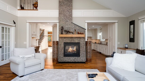 A spacious living room with a fireplace, white sofas, and a wooden floor. - MINNeSTAY* Dean Parkway Estate Luxury | Spacious (Minneapolis)