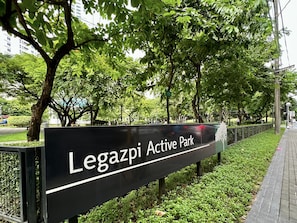 A sign for Legazpi Active Park with a paved walkway and greenery. -  KL Tower - Clean & Cozy 1BR Unit near Greenbelt Mall Makati City (Makati)