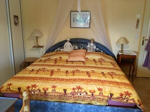 Relax in comfort with a large bed, bedside table, and elegant canopy.