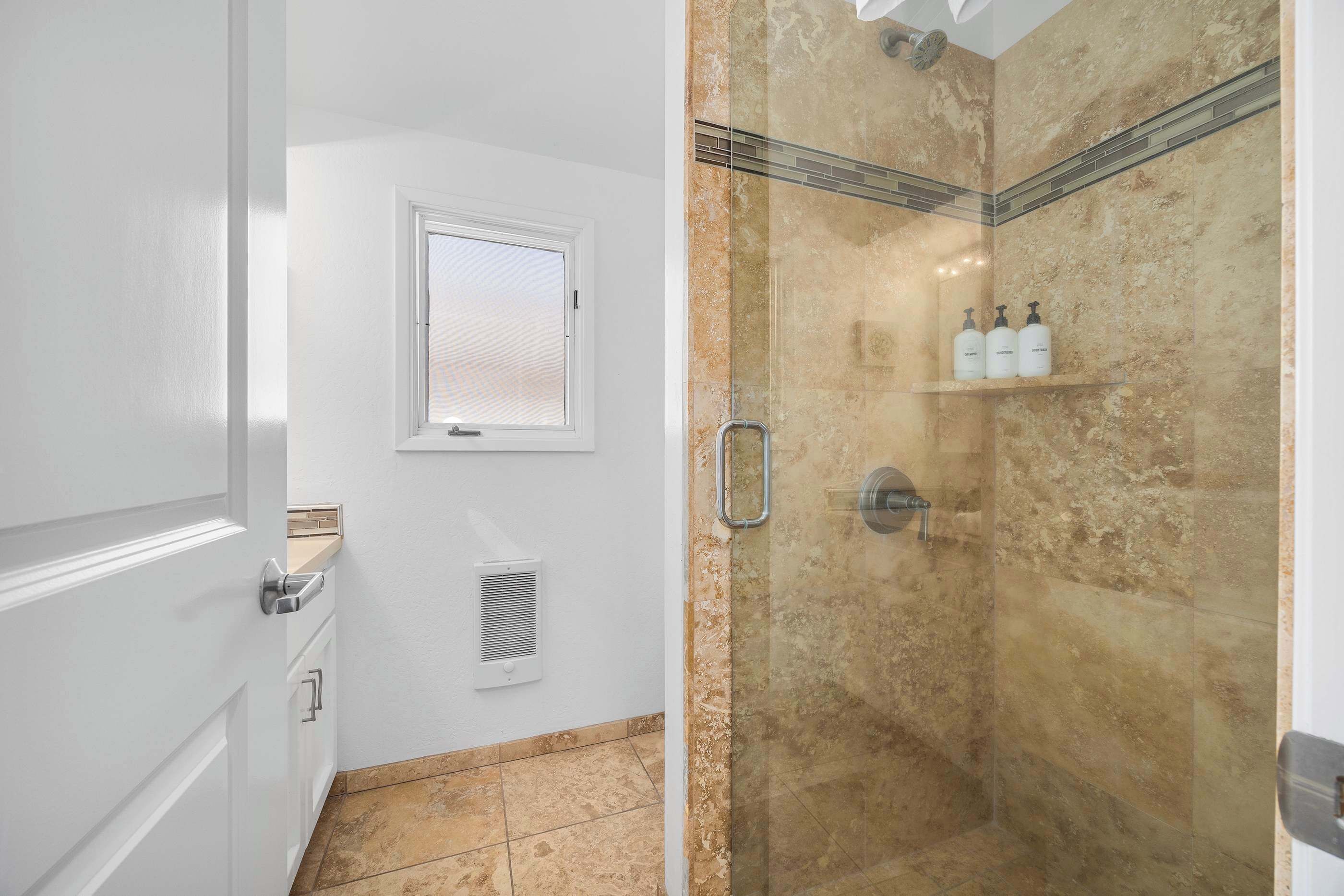 Bathtub, hair dryer, towels, shampoo