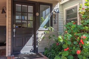 A front door with a window, a mailbox, and a number '328' on the wall.