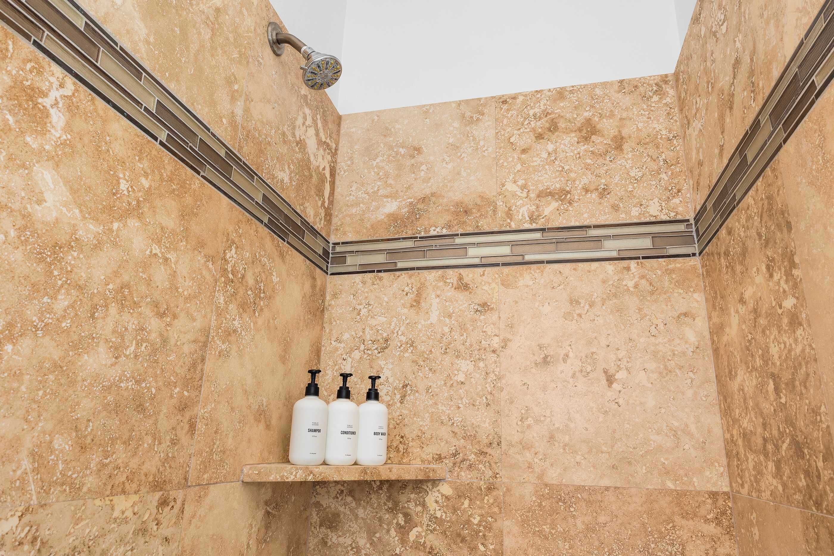 Bathtub, hair dryer, towels, shampoo