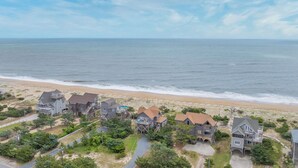 A coastal residential area with houses near the beach, featuring a mix of single and multi-story buildings, some with decks and balconies. - Oceanfront Dog Friendly Home w/ Hot Tub and Nearby Beach Access (Avon)