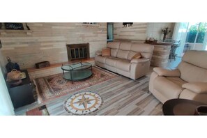 Cozy living room with a fireplace, sofa, and coffee table, perfect for relaxing.