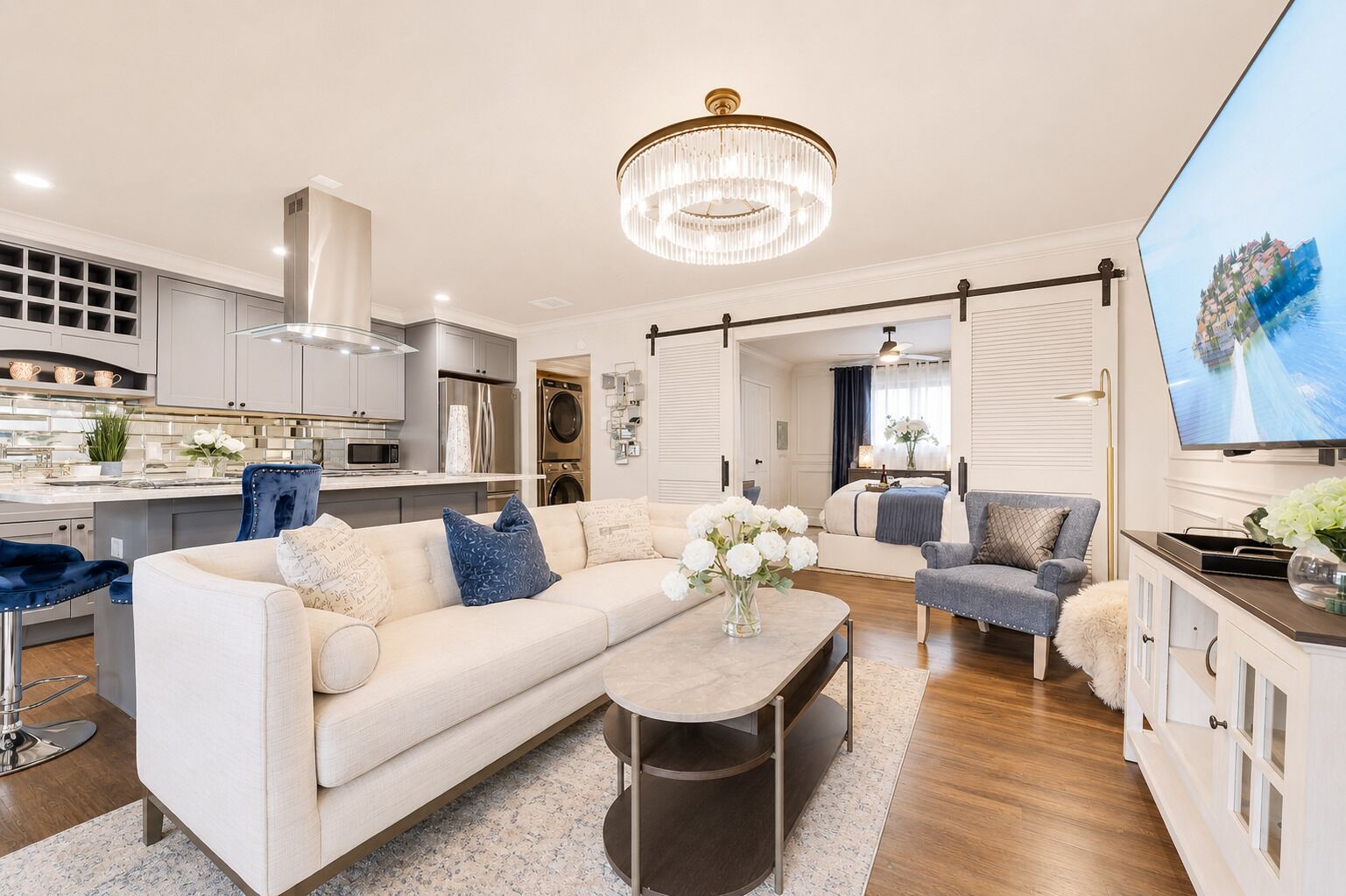 A modern living room with a sofa, coffee table, and a TV.