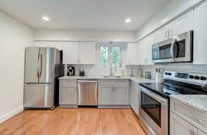 Enjoy cooking in this well-equipped kitchen with a refrigerator, dishwasher, and oven.