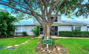 Stunning two-story home with a beautiful tree in the front yard.