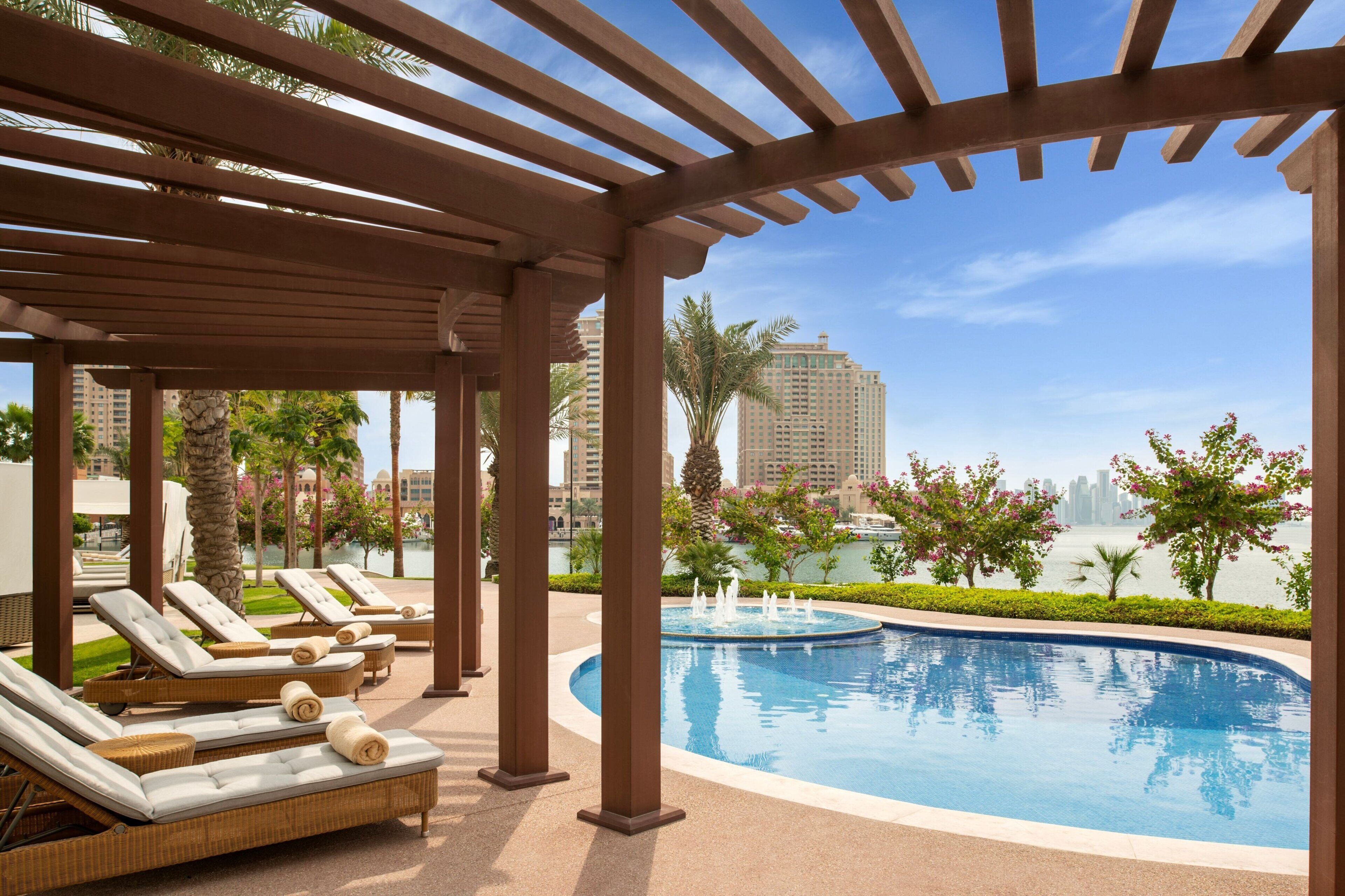 A poolside area with lounge chairs and a pool.
