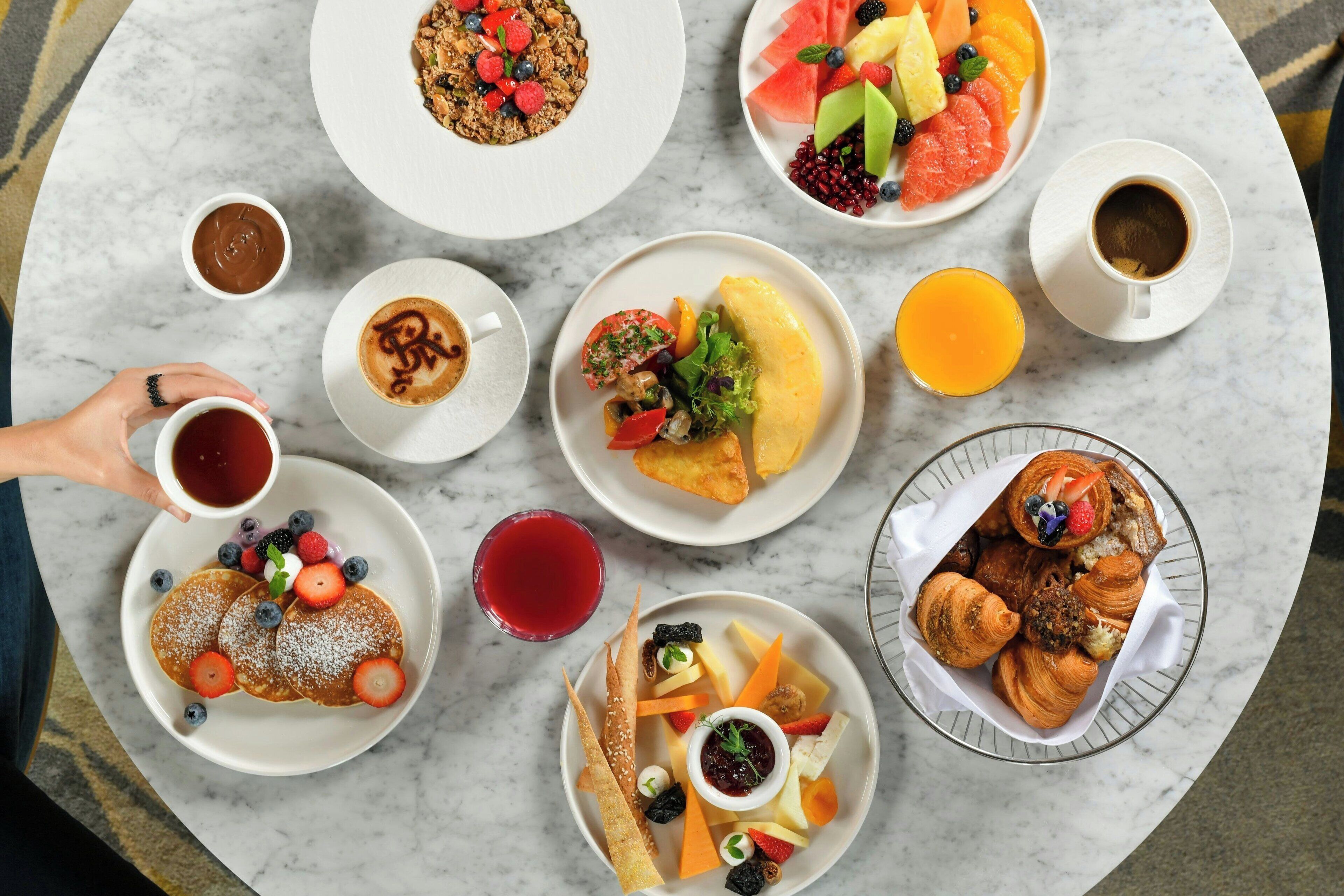 A breakfast buffet with various dishes and drinks.