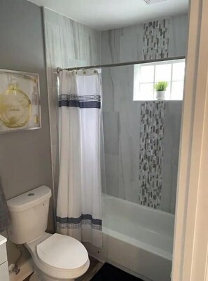 Shower, hair dryer, towels, toilet paper