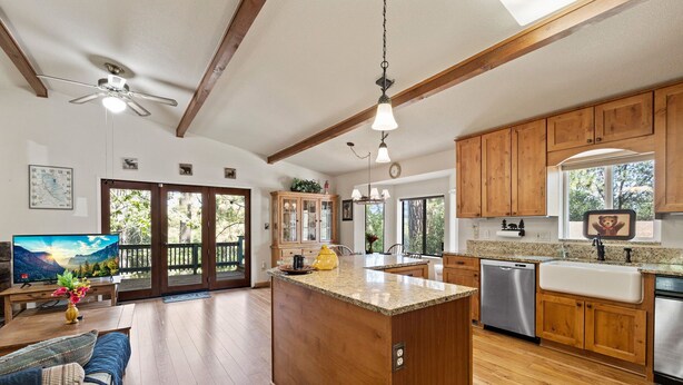 A spacious kitchen with wooden cabinets, a granite countertop, and a built-in dishwasher. - Yosemite Family Retreat: Dogs OK! Games, Lake, Deers, Golf, Family Reunion! (Groveland)