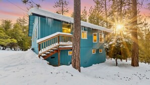 A two-story cabin with a wooden staircase and a deck, surrounded by snow and trees. - Yosemite Family Retreat: Dogs OK! Games, Lake, Deers, Golf, Family Reunion! (Groveland)