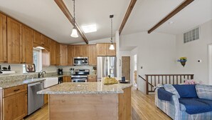 A kitchen with wooden cabinets, stainless steel appliances, and a granite countertop. - Yosemite Family Retreat: Dogs OK! Games, Lake, Deers, Golf, Family Reunion! (Groveland)