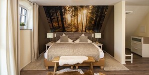 A bedroom with a large forest mural, a bed with a wooden headboard, bedside tables with lamps, and a small bench. - Landgasthof zur Sonne (Dillingen an der Donau)