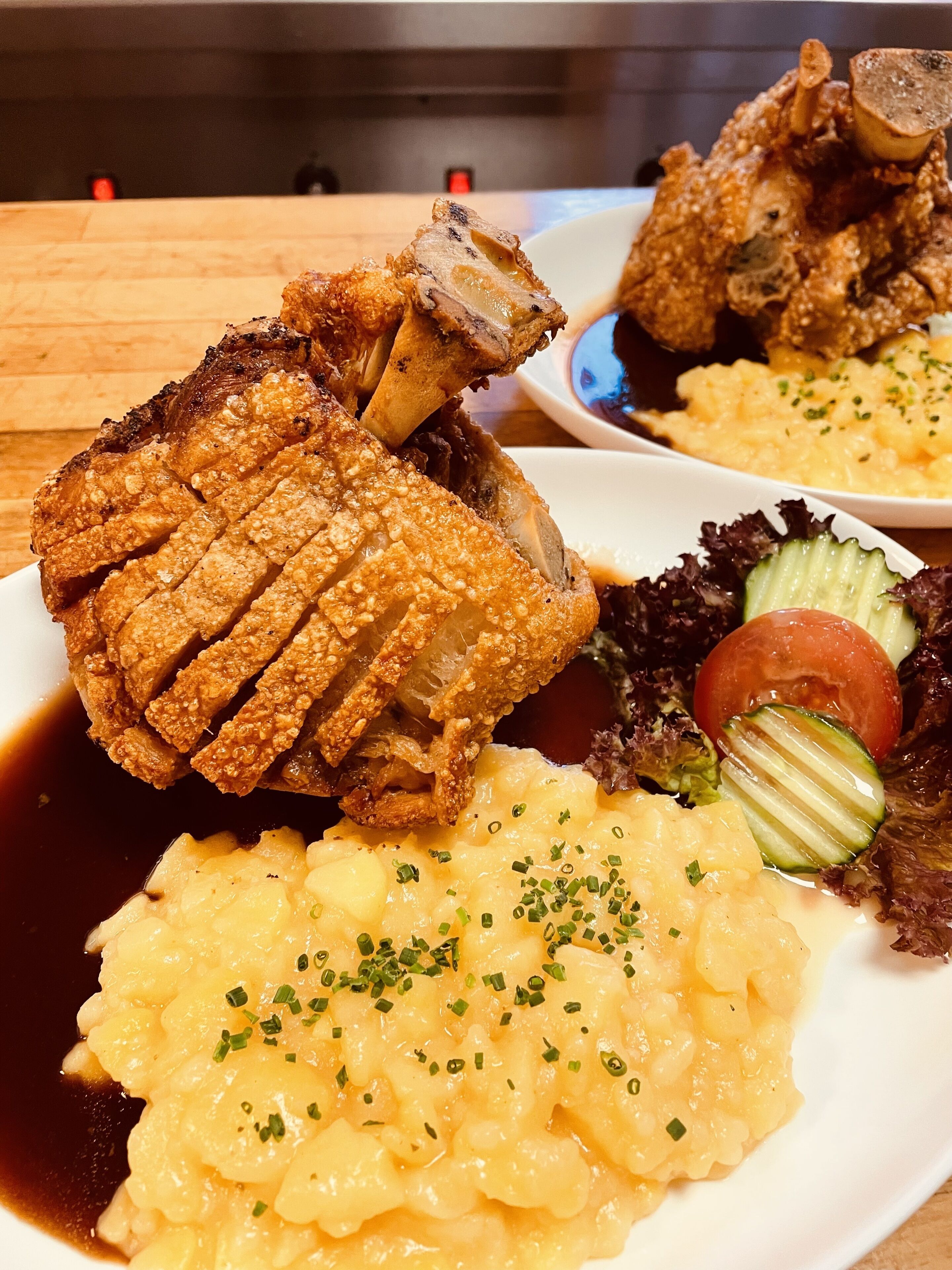 A plate of food with fried chicken, mashed potatoes, and a side salad.
