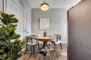 A dining area with a round table, four chairs, and a pendant light. - A relaxed one-bedroom escape with refined interiors, peaceful surroundings, and thoughtful comforts, offering an inviting place to recharge while exploring Dallas.🎡 STAY MINUTES FROM THE STATE FAIR OF TEXAS! 🎡 (Dallas)