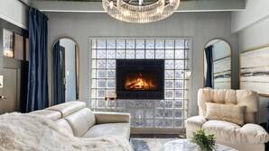 A living room with a fireplace, a sofa, a chair, and a coffee table.