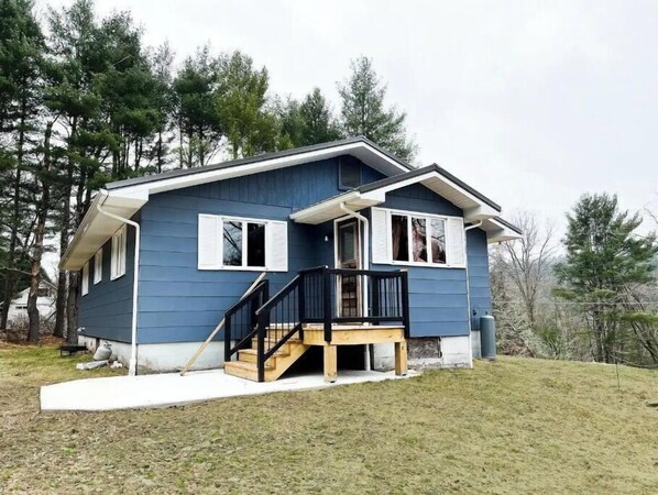 Stroll up to this charming two-story home, featuring a spacious deck and beautifully manicured lawn.