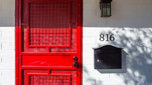 A red door with a black mailbox and a house number 816 on a white brick wall. - Quaint Central Phoenix Duplex   (Phoenix)