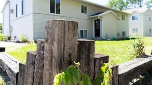 A two-story building with a flat roof and a front porch. - 1BR I Downtown, Queen, Free W/D, Garage (Fargo)