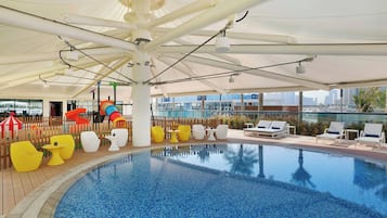 Relax by the pool with a view of the city skyline.