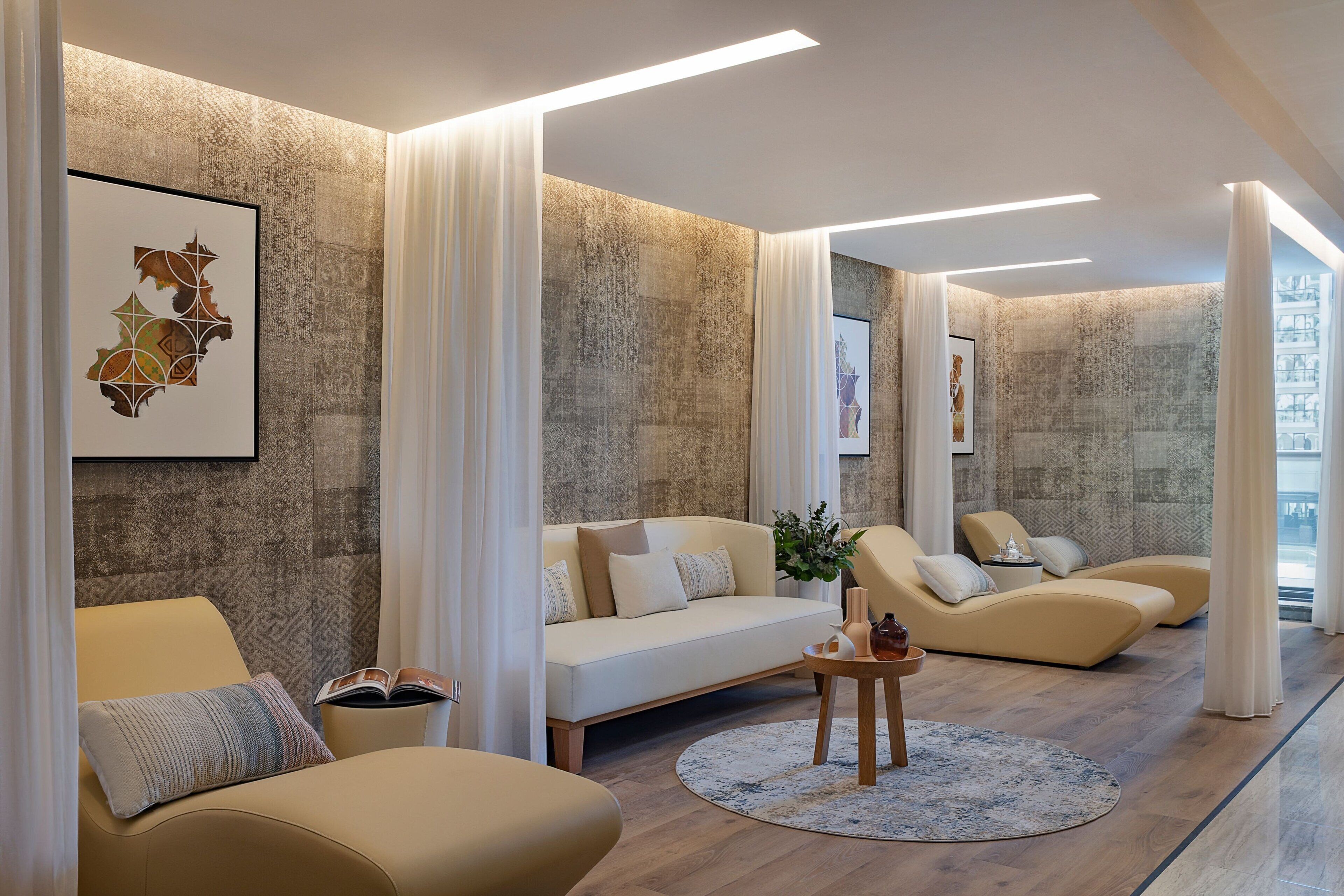 A modern living room with a sofa, armchairs, and a coffee table.