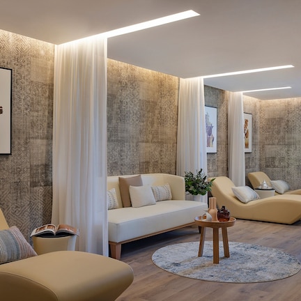 A modern living room with a sofa, armchairs, and a coffee table.