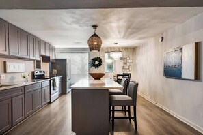 Fridge, microwave, oven, stovetop - Sophisticated 2-Bed, 1.5-Bath furnished condo in central Dallas with a private patio, serene garden views, and exclusive access to an award-winning courtyard equipped with premium wellness products and relaxing lounge areas. (Dallas)