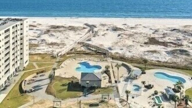 A beachside resort with multiple swimming pools, a small building, and a parking area. - BEACHFRONT Ground Floor WALK-OUT 3Bdrm/2Ba Plantation Palms Great for Families (Gulf Shores)