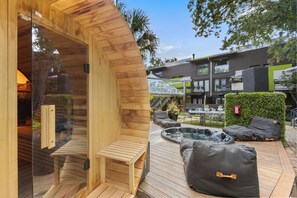 Terrace/patio - Experience elevated comfort in this upscale 2-bedroom Dallas condo with pool views and exclusive access to an award-winning courtyard featuring a resort-style pool, hot tub, dry sauna, and lush lounge areas. Enjoy a 77″ smart TV, sleek leather sofa, (Dallas)