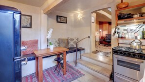 A compact kitchen with a refrigerator, stove, and dining area. - Adobe Studio: 2 Blocks to Dtwn Santa Fe Plaza! (Santa Fe)
