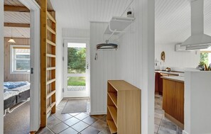 Cozy retreat with a functional layout, featuring a bed, window, and access to an outdoor area.